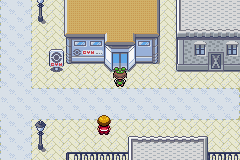 [Image: The protagonist standing in front of the Rustboro City Gym once more.]